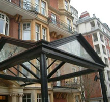 Painted aluminium, glazed canopy with frosted gables end and glass panels.