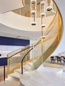 Helical staircase balustrading in JDL Amron PVD Architectural mesh IPZ-56 in Champagne with solid framing also in PVD coloured stainless steel in Champagne. Offices, 22 Bishopsgate, London - Client: THB Group Insurance - Architect: T.P.Bennett - Key contractor: James Engineering - Mesh product: JDL Amron PVD Architectural mesh