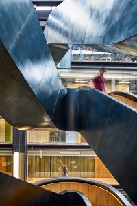 Staircase in blackened stainless steel with over-wax finish for Google headquarters. Google offices, 6 Pancras Square, London, UK - Architects: AHMM - Main contractor: ISG - Staircase fabrication, installation and finishing: John Desmond Ltd - Structural engineers for John Desmond Ltd: AECOM - Photography by Tim Soar