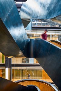 Staircase in blackened stainless steel with over-wax finish for Google headquarters. Google offices, 6 Pancras Square, London, UK - Architects: AHMM - Main contractor: ISG - Staircase fabrication, installation and finishing: John Desmond Ltd - Structural engineers for John Desmond Ltd: AECOM - Photography by Tim Soar