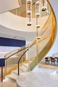 Helical staircase balustrading in JDL Amron PVD Architectural mesh IPZ-56 in Champagne with solid framing also in PVD coloured stainless steel in Champagne. Offices, 22 Bishopsgate, London - Client: THB Group Insurance - Architect: T.P.Bennett - Key contractor: James Engineering - Mesh product: JDL Amron PVD Architectural mesh
