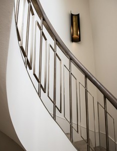 Showing the curved sweep of the staircase with balustrades in Almond Gold stainless steel. Architect: Nash Baker Interior Designer: Desalles Flint Architectural metalworks and PVD coated coloured stainless steel, John Desmond Ltd.