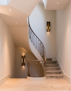 The first landing of the staircase showing the stone treads, risers and landing. Architect: Nash Baker Interior Designer: Desalles Flint Architectural metalworks and PVD coated coloured stainless steel, John Desmond Ltd.