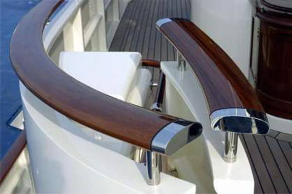 Polished timber yacht hand rail with chrome finish end-caps and struts