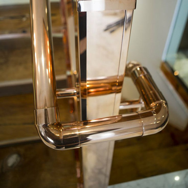 ￼Copper handrail and newel post to staircase by interior designer Katharine Pooley