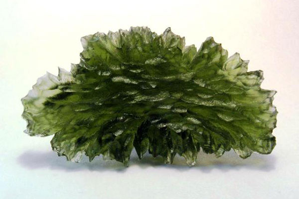 A green natural glass called Moldavite which may be formed as a consequence of meteoric impact. H. Raab, Creative Commons License
