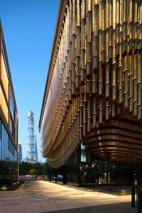 PVD stainless steel in Rose Gold Vibration glows in an evening shot of the Shanghai Bund Arts and Cultural Centre. - Architects: Foster & Partners; Heatherwick Studio - PVD: John Desmond Ltd in partnership with Double Stone Steel, Photography by Tim Franco.