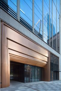 PVD stainless steel in Rose Gold Vibration reflects the light with this stepped door entry at the Shanghai Bund Financial Centre. Architects: Foster & Partners; Heatherwick Studio PVD: John Desmond Ltd