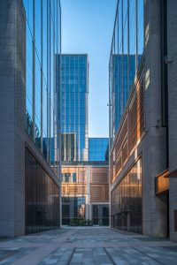 A dramatic avenue between the buildings at the Shanghai Bund Financial Centre showing PVD stainless steel in Rose Gold Vibration used for door reveals and window surrounds. Architects: Foster & Partners; Heatherwick Studio PVD: John Desmond Ltd, Photography by Tim Franco.