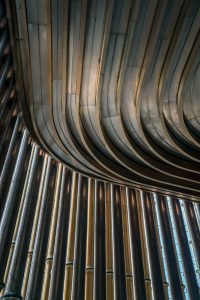 A view of the moving veil of tubes looking up at the undulating ceiling detail at the Shanghai Bund Arts and Cultural Centre. Fabricated from PVD stainless steel in Rose Gold Vibration. Architects: Foster & Partners; Heatherwick Studio PVD: John Desmond Ltd
