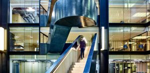 Staircase in blackened stainless steel with over-wax finish for Google, 6 Pancras Square, London, UK - Architects: AHMM - Main contractor: ISG - Staircase fabrication, installation and finishing: John Desmond Ltd - Structural engineers for John Desmond Ltd: AECOM - Showing view from below the stairs. Photography by Tim Soar