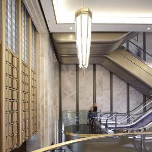 The renovated escalator hall in an Art Deco palette of almond gold, nickel bronze, black and white. Architectural design by Make Architects. PVD coloured stainless steel by John Desmond Ltd.