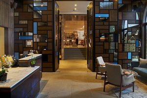 The Reception area looking through to the Champagne Bar. The Devonshire Club Hotel Interior Design: March & White PVD coloured stainless steel: John Desmond Ltd