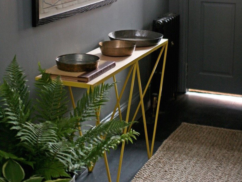 &New's Giraffe Console table here shown in yellow powder-coated steel.