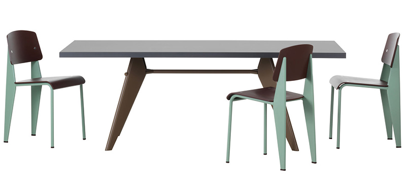 The EM table designed by Jean Prouvé in 1950 and sold today through Vitra. The table here is shown with an ashphalt 67 top and chocolate 40 powder-coated legs. Shown here with Prouvé’s Standard Chair with Japanese red 06 chair back and seat and mint 91 powder-coated base.
