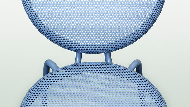 Close up of the perforated powder coated steel back and seat of Alexander Lervik’s Dimma chair