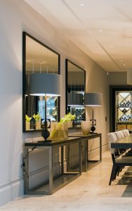 Console table with over-sized mirrors in dining/wine-tasting area. Bedford Gardens, London. Architects: Nash Baker Interior Designers: DeSalles Flint Architectural metalwork & PVD stainless steel: John Desmond Ltd