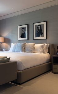 Bedroom with black and white portrait photography. Bedford Gardens, London. Architects: Nash Baker Interior Designers: DeSalles Flint Architectural metalwork & PVD stainless steel: John Desmond Ltd