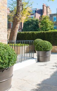 Front garden with patinated brass planters. Bedford Gardens, London. - Architects: Nash Baker - Interior Designers: DeSalles Flint - Architectural metalwork & specialist metal finishes: John Desmond Ltd