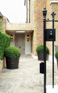 Entrance with PVD stainless steel planters and railings. Bedford Gardens, London. Architects: Nash Baker Interior Designers: DeSalles Flint Garden Designer Luciano Giubbilei Architectural metalwork & PVD stainless steel: John Desmond Ltd