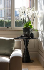 Ground floor formal sitting room corner arrangement with orchid. Bedford Gardens, London. Architects: Nash Baker Interior Designers: DeSalles Flint Architectural metalwork & PVD stainless steel: John Desmond Ltd