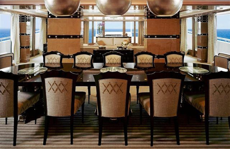 Dining area on the Oceanco Natita motor-yacht by Alberto Pinto. The silver space-invader light fittings are a bold and light-hearted touch.