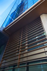 Looking up at the Brise soleil fins and verticals. 15 Fetter Lane, EC4A, London. PVD coloured stainless steel Brise soleil, canopy and column. John Desmond Ltd.