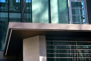 Detail of the canopy. 15 Fetter Lane, EC4A, London. PVD coloured stainless steel Brise soleil, canopy and column. John Desmond Ltd.