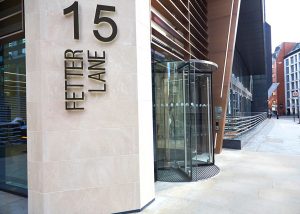 Limestone column and entrance. 15 Fetter Lane, EC4A, London. PVD coloured stainless steel Brise soleil, canopy and column. John Desmond Ltd.