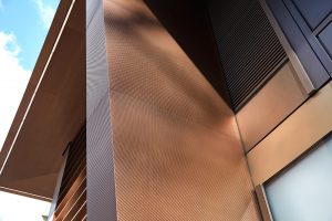 The column integrating with the existing façade. 15 Fetter Lane, EC4A, London. PVD coloured stainless steel Brise soleil, canopy and column. John Desmond Ltd.