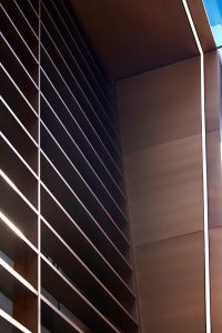 Detail of the V-grooved hollow fins and column. 15 Fetter Lane, EC4A, London. PVD coloured stainless steel Brise soleil, canopy and column. John Desmond Ltd.