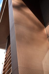 The texture of the PVD stainless steel. 15 Fetter Lane, EC4A, London. PVD coloured stainless steel Brise soleil, canopy and column. John Desmond Ltd.