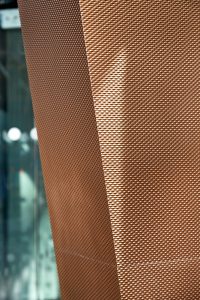 The texture of the PVD stainless steel. 15 Fetter Lane, EC4A, London. PVD coloured stainless steel Brise soleil, canopy and column. John Desmond Ltd.