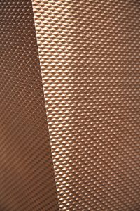 The texture of PVD coloured stainless steel in Chocolate with embossed finish SB-H25. 15 Fetter Lane, EC4A, London. John Desmond Ltd.