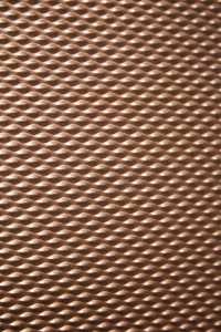 The texture of PVD coloured stainless steel in Chocolate with embossed finish SB-H25. 15 Fetter Lane, EC4A, London. John Desmond Ltd.