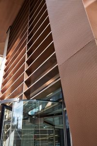 15 Fetter Lane, EC4A, London. PVD stainless steel Brise soleil, canopy and column. Showing the relocated entrance on Fetter Lane. John Desmond Ltd.