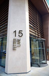 The limestone column forming a centre-section to the PVD coloured stainless steel Brise soleil, canopy and column. 15 Fetter Lane, EC4A, London. John Desmond Ltd.