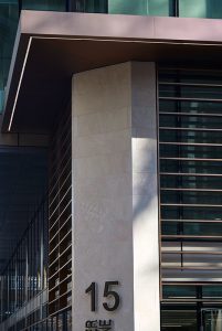 The limestone column creates cosmetic support. 15 Fetter Lane, EC4A, London. PVD coloured stainless steel Brise soleil, canopy and column. John Desmond Ltd.