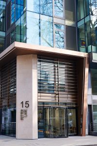 The new entrance façade. - 15 Fetter Lane, EC4A, London. - Bronze PVD coloured textured stainless steel in Chocolate for Brise soleil, canopy and column. - Architectural metalworks and PVD by John Desmond Ltd.