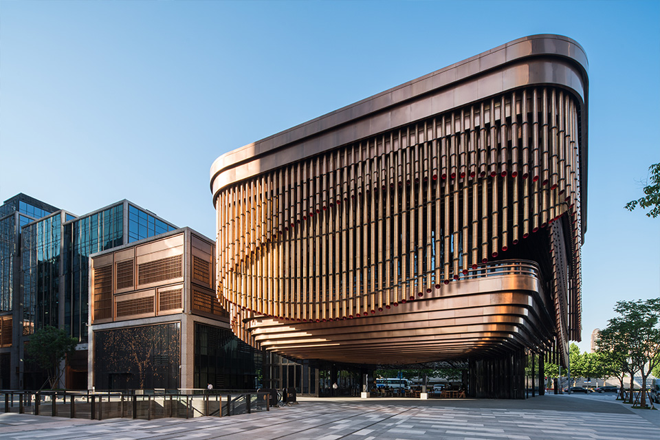 Double Stone Steel PVD stainless steel in Rose Gold for façades and tubular drops: John Desmond Ltd. The Arts and Cultural Centre, Shanghai Bund Financial Centre, China. - Architects: Foster & Partners; Heatherwick Studio