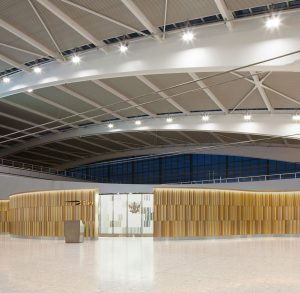 Undulating 3 metre high screen in Chocolate, Champagne and Almond Gold PVD coloured stainless steel forms entrance to British Airways Private Check-In, Heathrow Terminal 5, London. - Architects/Interior Designers: Universal Design Studio - PVD Coloured Stainless Steel: Double Stone Steel Europe Ltd - Photography: Paul Greenleaf