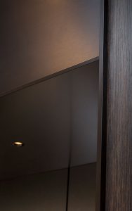 Vertical and horizontal trim in V-Grooved stainless steel with Bronze finish. Elevator architrave and panels in V-Grooved electro-zinc coated stainless steel Fenman House, Apartment Building, 9 Handyside St, King’s Cross, London N1C Manufacture by Bluecoat Engineering Fabrication, V-Grooving and folding of stainless steel by John Desmond Ltd