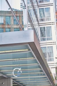 Frameless Glazed Satin Stainless Steel Canopy. 1 Broadgate Quarter, Snowden St, London, EC2A 2AW - Architects: John Robertson Architects. - Stainless Steel Canopy: John Desmond Ltd. - The upgraded building design has now harmonised the building with its surroundings.