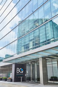 Frameless Glazed Satin Stainless Steel Canopy. 1 Broadgate Quarter, Snowden St, London, EC2A 2AW - Architects: John Robertson Architects. - Stainless Steel Canopy: John Desmond Ltd - Showing the new canopy design integrated into the original façade.