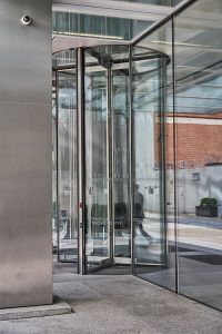 Frameless Glazed Satin Stainless Steel Canopy. 1 Broadgate Quarter, Snowden St, London, EC2A 2AW - Architects: John Robertson Architects. - Stainless Steel Canopy: John Desmond Ltd. - The revolving doors are integrated into the canopy space.
