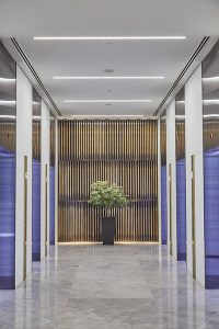 1 Broadgate Quarter, Snowden St, London, EC2A 2AW - Architects: John Robertson Architects. - Stainless Steel Canopy: John Desmond Ltd. - The feature wall of narrow brass bars creates a warm backdrop to the glossy, contemporary finishes.