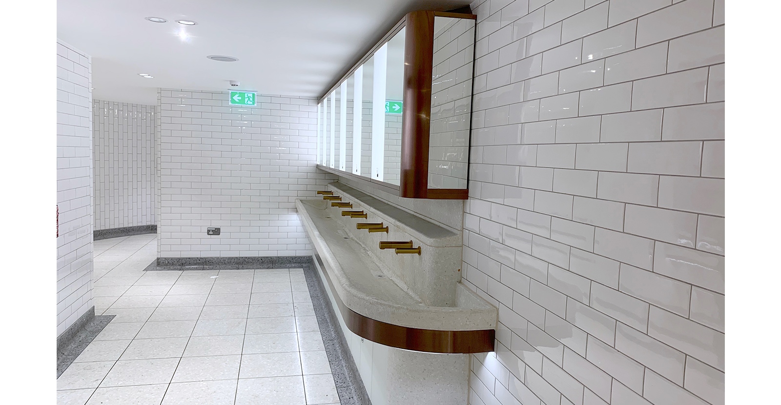 Communal sinks help to keep liquids in one place and floors dry and slip-free. London Victoria Rail Station WC. Architects Landolt + Brown, fit out contractor Maxwood Washrooms.