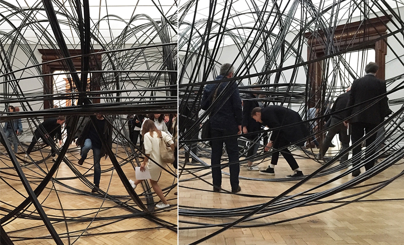 Clearing VII – people crawl, walk around and jump over a bundle of aluminium tubes, 8km in length. Installation by Antony Gormley at the Royal Academy. Photographs: Antonio Moll