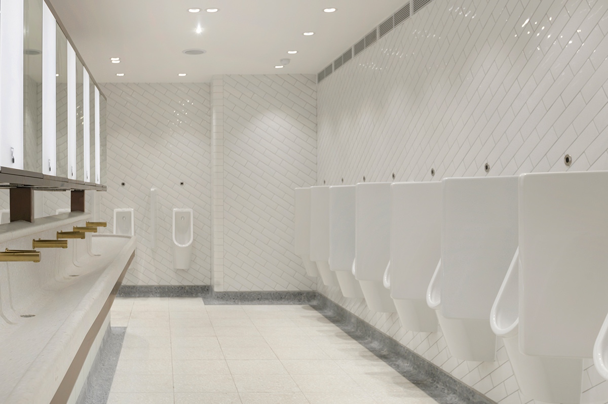 Interior of Gents urinals in the upgraded toilets, Victoria Station, London showing light, bright interior although underground.