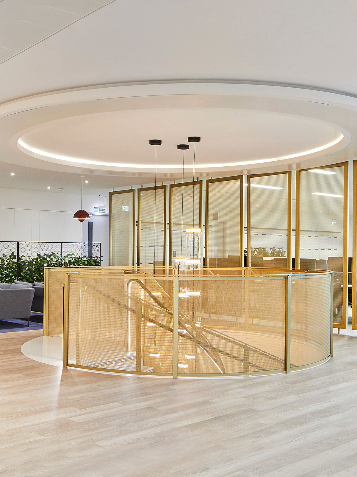 22 Bishopsgate, London. - Showing circular staircase gallery balustrading and floor and ceiling mounted space dividers in JDL Amron PVD Architectural Mesh IPZ-56 in Champagne with solid framing also in PVD coloured stainless steel in Champagne. - Architectural Mesh - IPZ-56 in Champagne with solid framing also in PVD coloured stainless steel in Champagne.